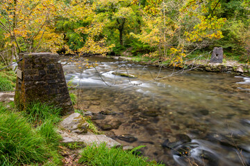 Long exposure of the river Barle flowing through the Barle Valley at Tarr Steps in Exmoor National Park