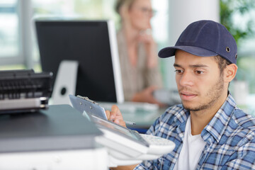 a printer technician checking dispositif
