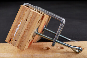 Gluing pieces of wood with carpentry glue. Minor carpentry work in the workshop.