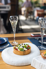 Fresh Tomato and Burrata Cheese Tart with Basil Leaves. Brunch in Restaurant