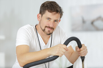 sporty man riding stationary bicycles in gym