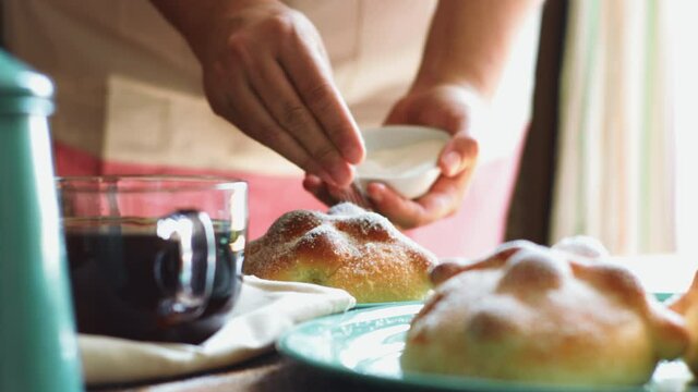 Panadera azucarando pan de muerto festividad religiosa dia de muertos