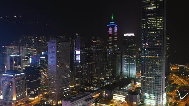 night time illuminated hong kong city downtown bay aerial panorama 4k