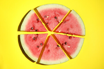 Watermelon slices on yellow background, flat lay