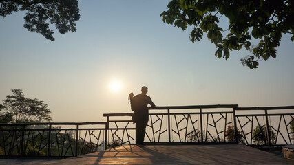 silhouette of a couple on the pier