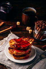 Stack of french toasts with berry syrup