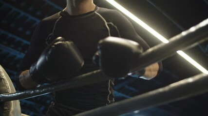 Angry sport man starting to attack at gym. Boxer starting fight on boxing ring