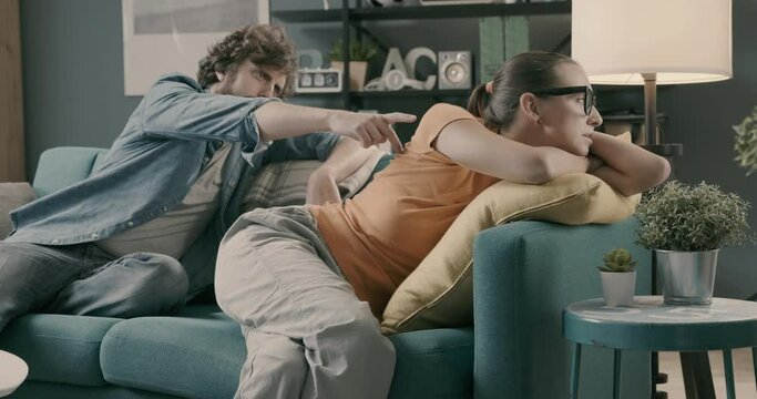 Young couple fighting at home and having relationship problems