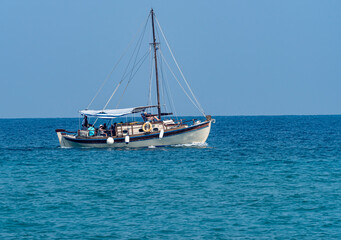 small tourist boat in blue sea