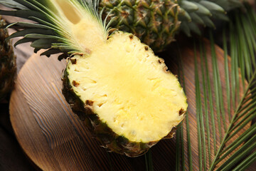 Half of pineapple on wooden board, closeup