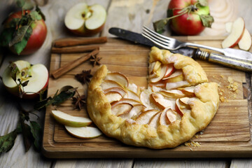 Apple biscuit on a wooden board. Galette. Homemade baking. Desserts with apples.