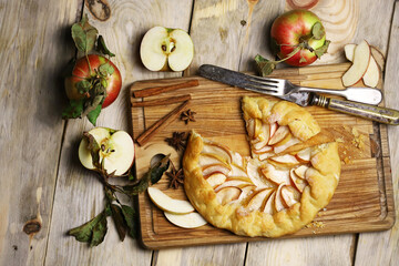 Apple biscuit on a wooden board. Galette. Homemade baking. Desserts with apples.