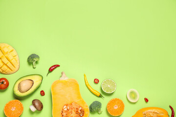 Flat lay composition with fresh organic fruits and vegetables on light green background. Space for text