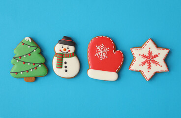 Different Christmas gingerbread cookies on light blue background, flat lay