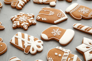 Different Christmas gingerbread cookies on grey background, closeup