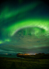 Naklejka na ściany i meble Aurora over Vestmannaeyjar Iceland.