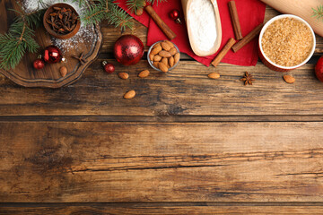 Flat lay composition with ingredients for traditional Christmas cake on wooden table. Space for text