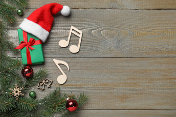 Flat lay composition with music notes on wooden background, space for text. Christmas celebration