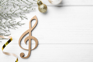 Flat lay composition with music note on white wooden background, space for text. Christmas...