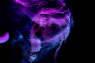 Abstract photography in the style of light painting. girl on a black background 