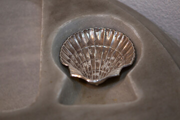 Silver christening shell on gray marble