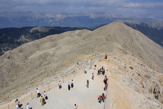 Olympos Teleferik Kemer, Antalya Region / Turkey - August 12th 2015: Summit of Tahtali, 2365 m MSL with people visible on foreground and mountain range in the background