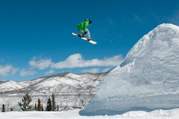 Naklejka na ściany i meble snowboarder jumping in the air