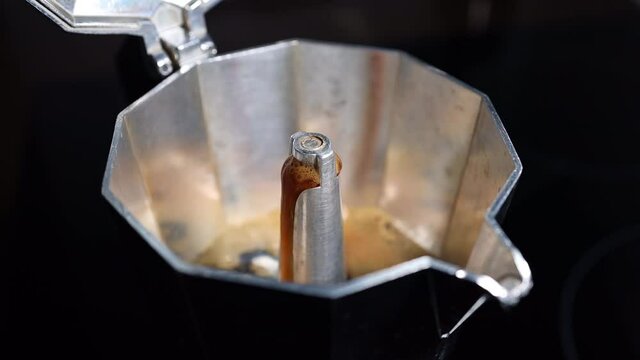 Boiling coffee coming out from a greca