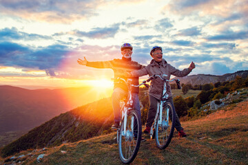 Fototapeta na wymiar Happy senior couple on their bike. Bicycle, activity. Celebrating