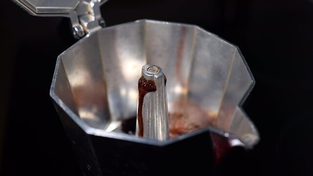 Boiling coffee coming out from an espresso machine