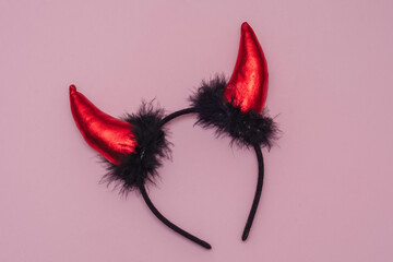 devil horns for halloween, mask for the holiday. Pink background.