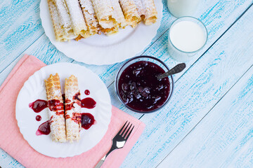 Homemade waffle rolls with milk and jam. Homemade cakes for Breakfast. The view from the top.