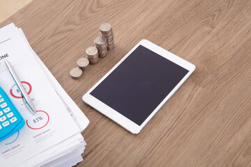 A row of dollar coins and related documents on the table