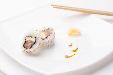 urakami style sushi roll on white plate and white background