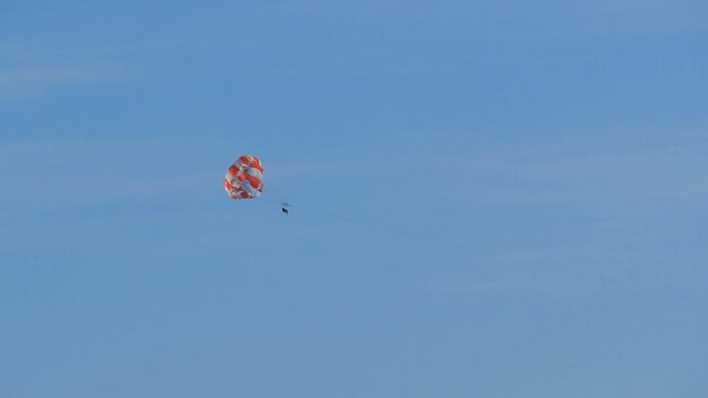People are resting flying on parasailing over the Adriatic Sea in the Bay of Kotor, Montenegro, outdoor activities.