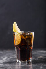 Refreshing alcohol cocktail Long Island Iced Tea in glass placed on table. High quality photo