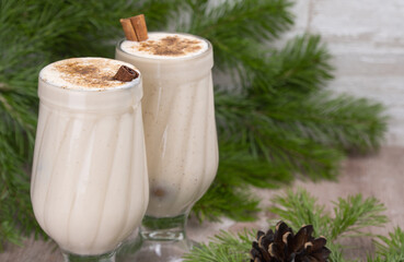 eggnog Christmas cocktail with grated nutmeg and cinnamon. Traditional holiday drink. selective focus