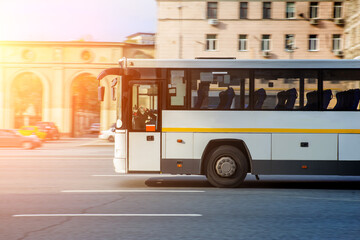 Fototapeta na wymiar Tourist Bus Moves On City Street
