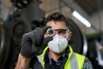 Worker check metal nut in manufacturer site