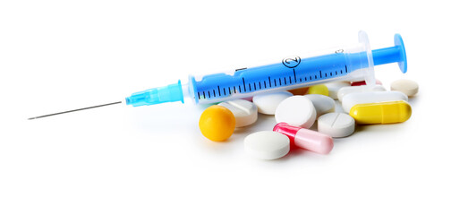 Pills and syringe for injection on white background