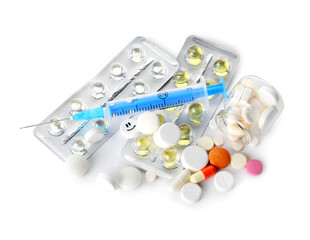Pills and syringe for injection on white background