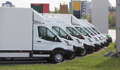New Trucks in a Parking lot in a row in the City. © Yuri Bizgaimer