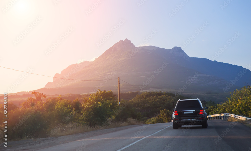 Canvas Prints Car Drives on Country Highway to the Mountains