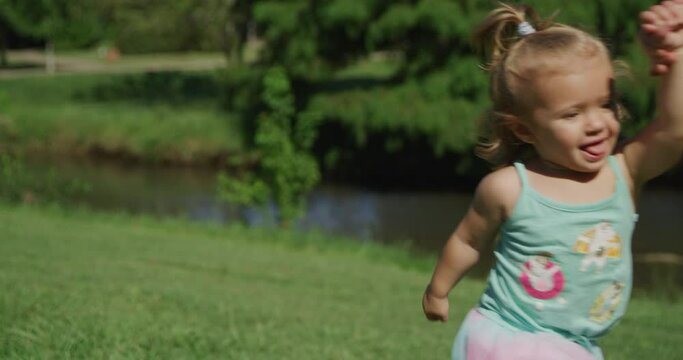 Young beautiful woman has fun running with her little baby girl in summer park. Slow motion 4k