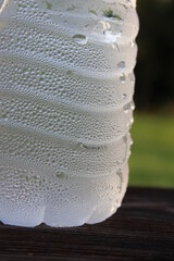 Condensation on a cold water bottle outdoors.