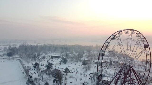 Irkutsk city covered in winter snow at sunset, Krugozor Ferris Wheel, aerial