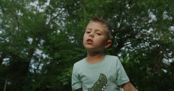 Cute little boy singing with microphone. Red cinema camera 4k