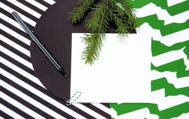 Mockup Christmas greeting card letter with natural fir, flatlay on black  white green striped background, with place for your text, Flat lay, top view photo mock up