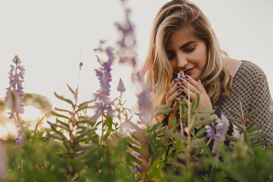 Woman Smelling Flowers