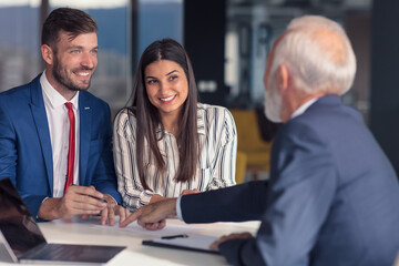 Young couple meeting financial advisor for home investment